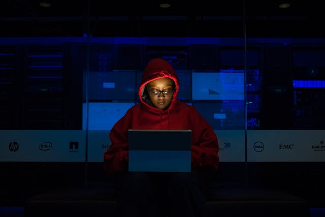 person in dark on computer